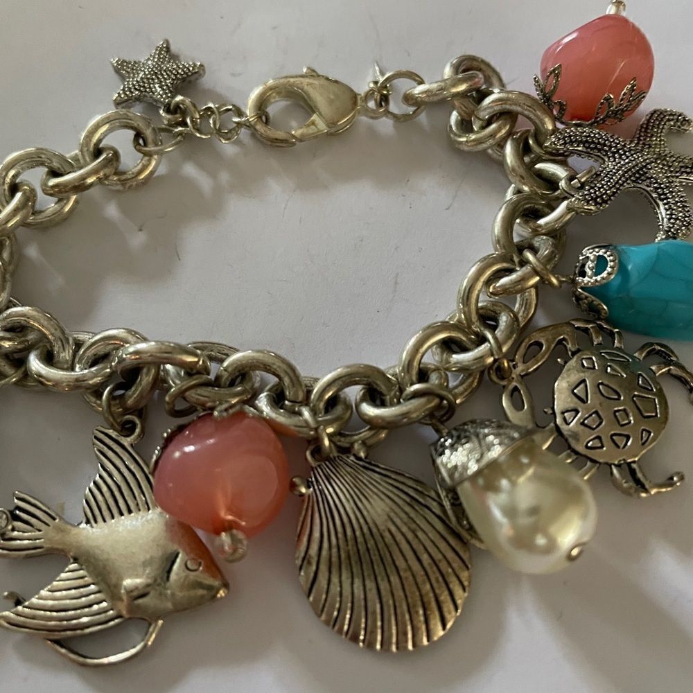 “Charming Silvertone Sea Life Bracelet - Dive into Coastal Delights!”